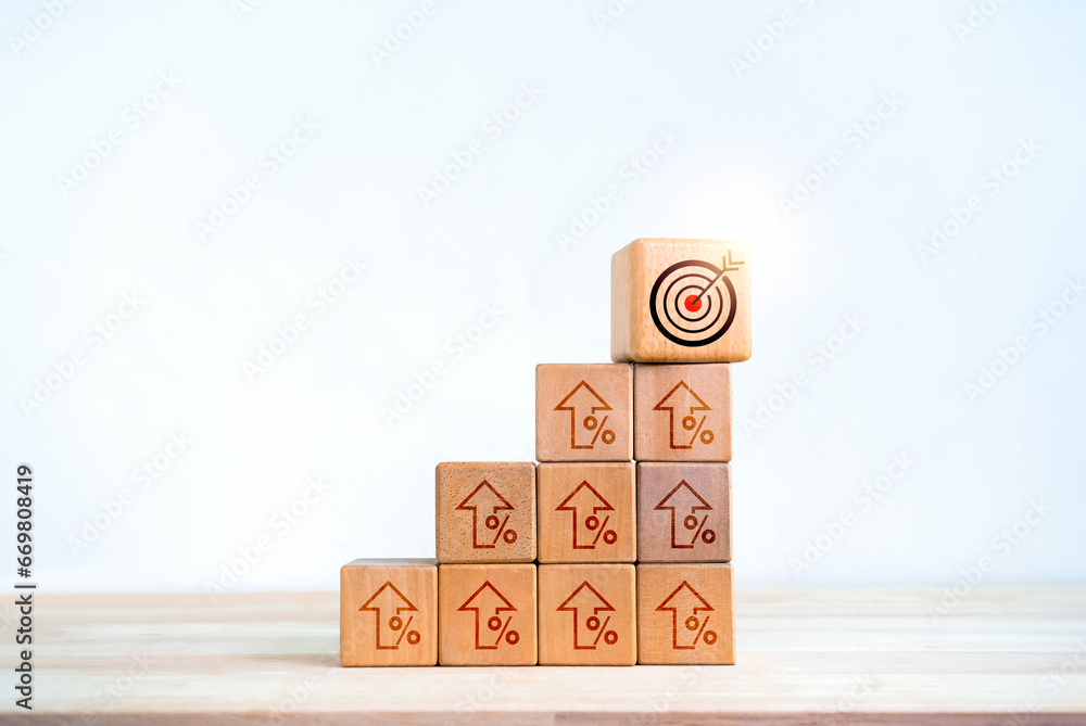 Poster target icon on wooden cube blocks on top of bar graph chart steps with rising percentage symbol isol