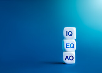 Text IQ,EQ and AQ on white blocks stack on blue background with copy space. Intelligence, Emotional...