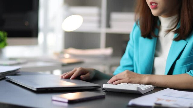 Businesswoman working with laptop in office, she is seriously working, is stressed and tired from failed tasks.