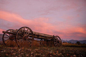 old farm wagon in Montana field blue pink sunset