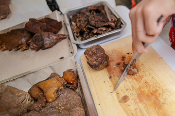 A man cuts beef to make a typical Betawi soto