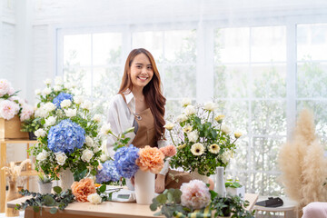 happiness smiling young lady making flower vase.Self employed florist working at flower shop.young...