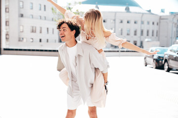 Young smiling beautiful woman and her handsome boyfriend in casual summer clothes. Happy cheerful...