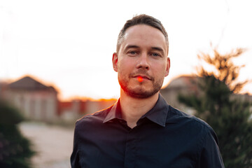 Portrait of handsome successful man standing outdoors