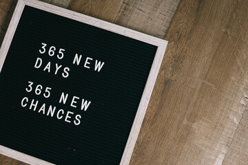 Motivational quote on letter board, 365 New Days, 365 New Chances on wooden background. Goal setting, self improvement and development concept.