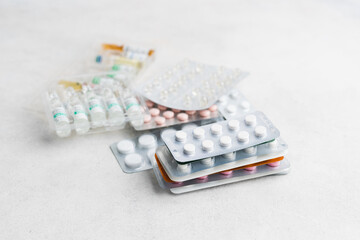 Pile of various pills and tablets in a blister pack on white background, healthcare and medicine...