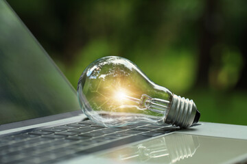 Renewable Energy.Environmental protection, sustainable energy sources. light bulb on a laptop with...