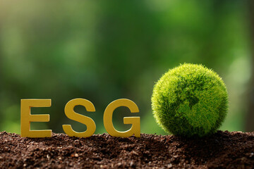 ESG concept of environmental, social and governance.ESG wooden letter and the green world on green...