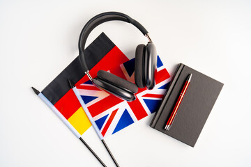 German and British flags with notepad on white background