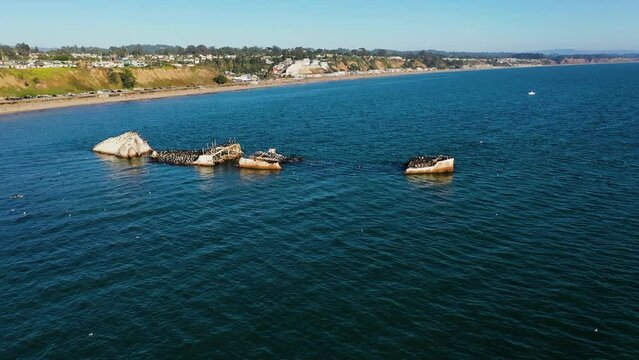Aerial view around a shipwreck on the coast of Rio del Mar, sunny California, USA