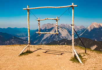 Fototapeta na wymiar Alpine summer view with a wooden foto frame at Mount Seefelder Joch, Rosshuette, Seefeld, Tyrol, Austria