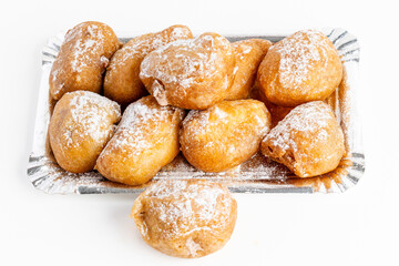 Plate of buñuelos de viento with cream and truffle typical dessert of the day of the saints in Spain