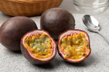 Whole and halved fresh tropical passion fruit close up