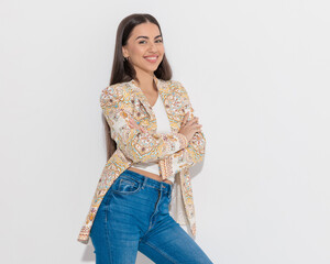 happy businesswoman with paisley print jacket crossing arms and smiling