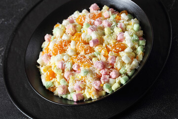 Ambrosia Salad in black bowl, top view