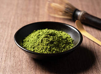 Matcha and Chasen on wooden background.