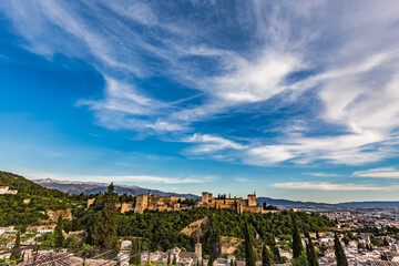 Fototapeta na wymiar Alhambra as seen over the roofs of the buildings in Granada, Andalusia, Spain