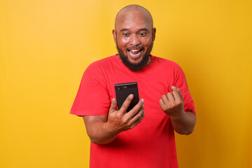 Excited bald bearded man using smartphone winning game, getting cashback online gift in mobile app...