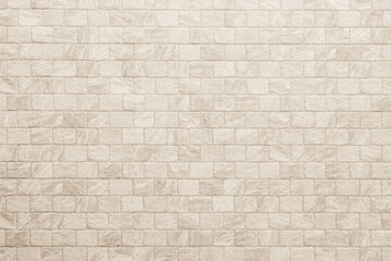 Empty background of wide cream brick wall texture. Beige old brown brick wall concrete or stone textured, wallpaper limestone abstract flooring. Grid uneven interior rock. Home decor design backdrop.