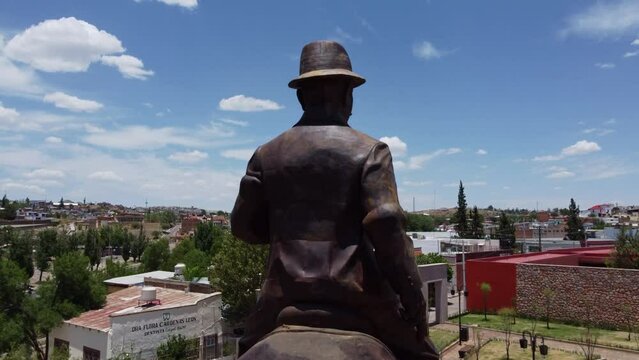 shot of the statue of pancho villa in el parral doing a survey with the drone to discover the city