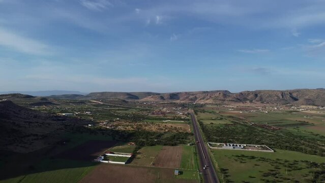 view of pots and mountains of Mexico with a road in the background
