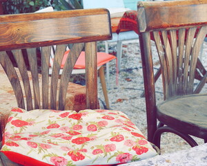 Vintage Chairs and a Pillow. Retro Wooden Furniture. Floral Pattern. Outdoor