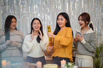 Cheerful friends enjoying home Birthday holiday party. Asian Friends celebrating.