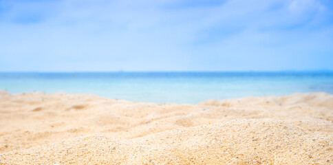 Beach sand background for summer vacation concept. Beach nature and summer seawater with sunlight light sandy beach Sparkling sea water contrast with the blue sky