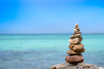 Stacks of pebbles pyramid stone balancing on beach on background ocean .concept zan 