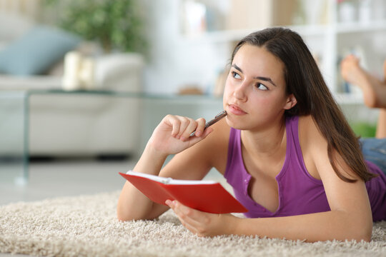 Woman with agenda thinking and planning at home