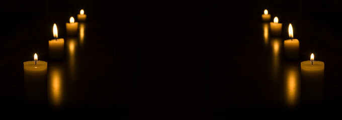 Dark night with lit candles in the corners of the image for background