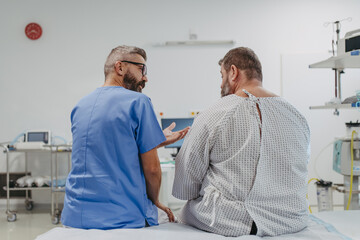 Supportive doctor soothing a worried overweight patient, discussing test result in emergency room. Illnesses and diseases in middle-aged men's health. Compassionate physician supporting stressed - obrazy, fototapety, plakaty