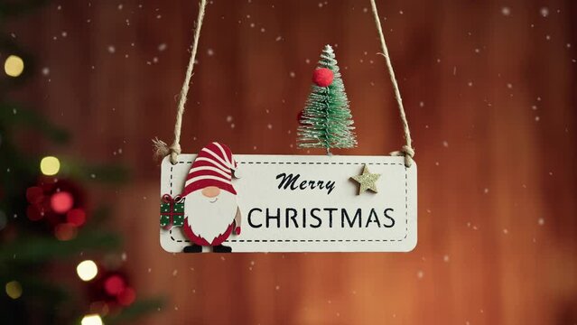 Merry Chistmas patch hanging with decorated tree in the background 