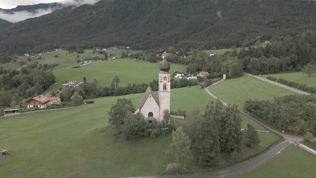 Ascending drone footage of St. Constantine Church and Schlern mountain in Fie allo Sciliar, Italy