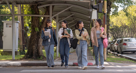 Happy young student chat with each other after class. Guy and girls wear casual clothes to study. Lifestyle concept, sincere emotions