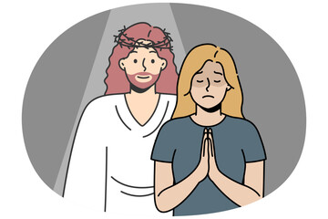 Christian woman prays to God with her palms together in prayer. Jesus Christ appeared to blonde girl in response to her request. Angel appeared in crisis moment, despair to give comfort, hope, love.