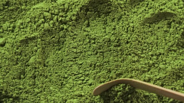 Move the matcha powder with a bamboo spoon.