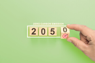 Net zero by 2050. cubes with 2050 net zero. hand holding wooden cube with target. Net zero...