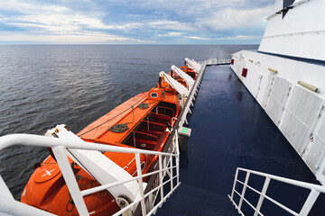 Cruise ship deck and lifeboats, action on the high seas.
