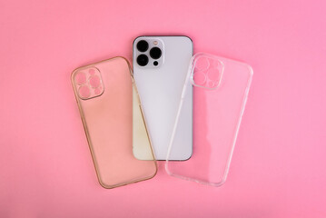 New and dirty silicone transparent phone cases and smartphone on pink background - obrazy, fototapety, plakaty