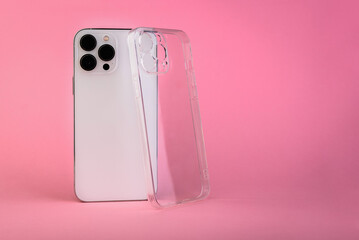 Silicone transparent phone case and smartphone on pink background
