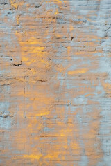 Fragment of the grunge wall, stucco rough surface. Sandstone and cyan, vertical. Background or texture for design