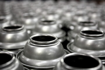 Close up of aerosol cans being manfactured in factory