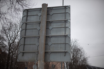 Road sign at the back. A pole with a sign on the reverse side. The design of the road sign.