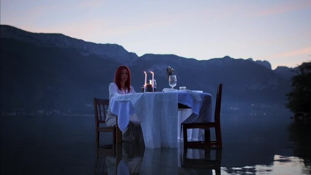 Woman sitting at a table in a lake