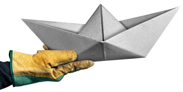 Hand with protective work glove of a manual worker holding a white paper boat, isolated on white or transparent background. Shipyard or safe harbor concept. Png.