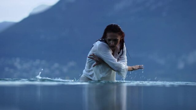 Woman dancing in a lake