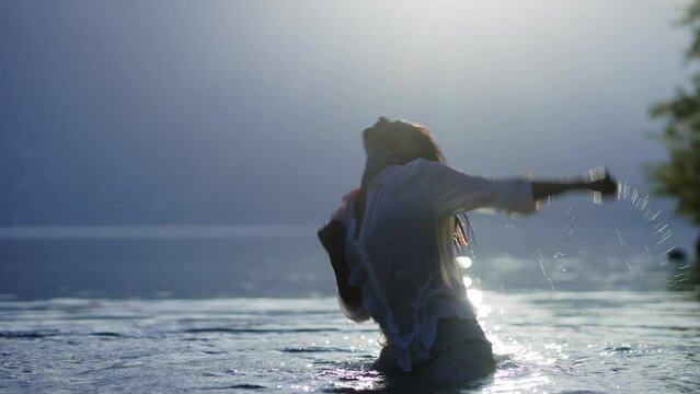 Woman dancing in a lake