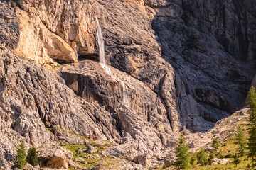Fototapeta na wymiar Alpine summer view with a waterfall near Passo Gardena, Dolomites, South Tyrol, Italy