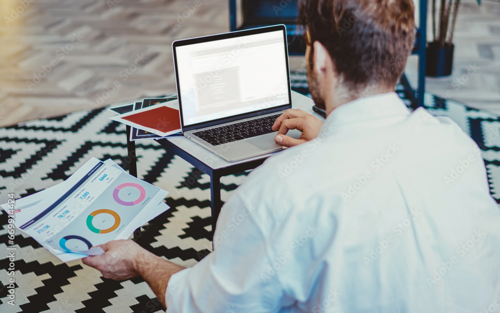 Aufkleber back view of man sitting on floor with laptop device with copy space area for your internet content